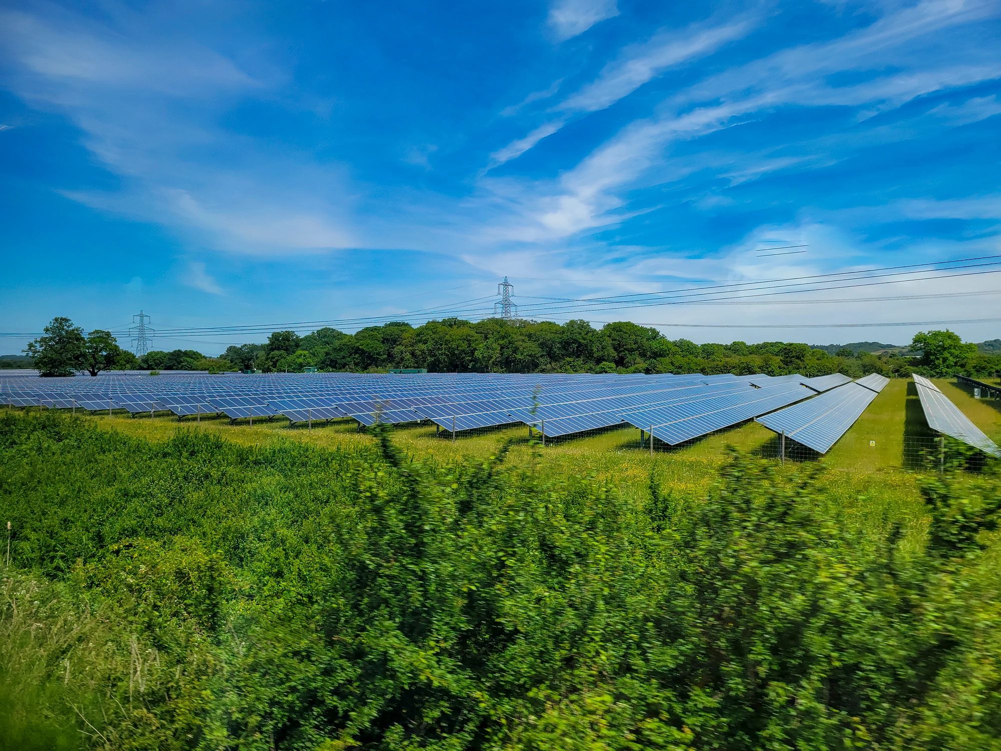 Solar panels installed across a rural farm field