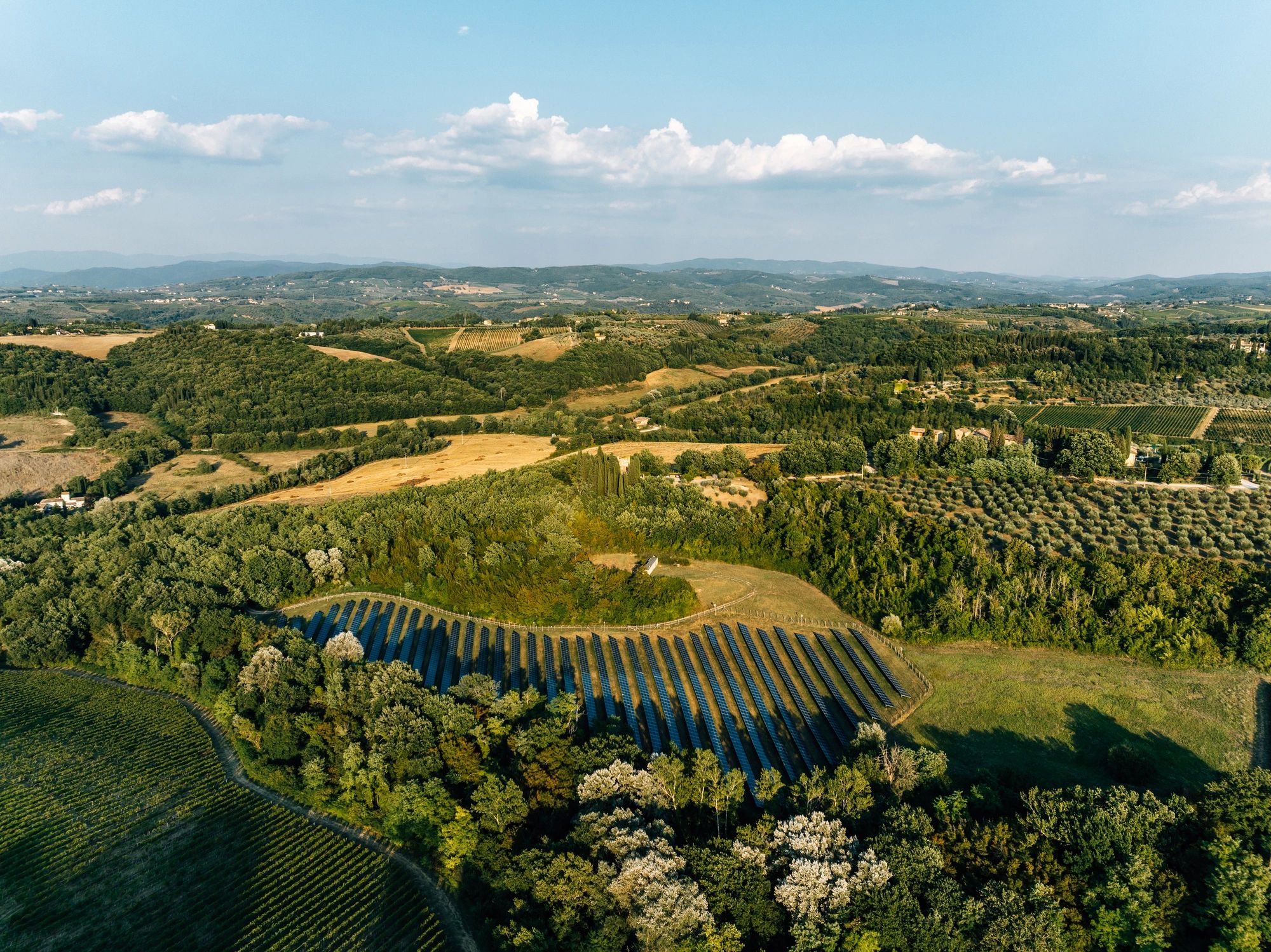 Solar panels supporting agricultural operations on open farmland